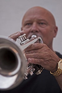 Music teacher and band member, Don Haudenschild, playing trumpet